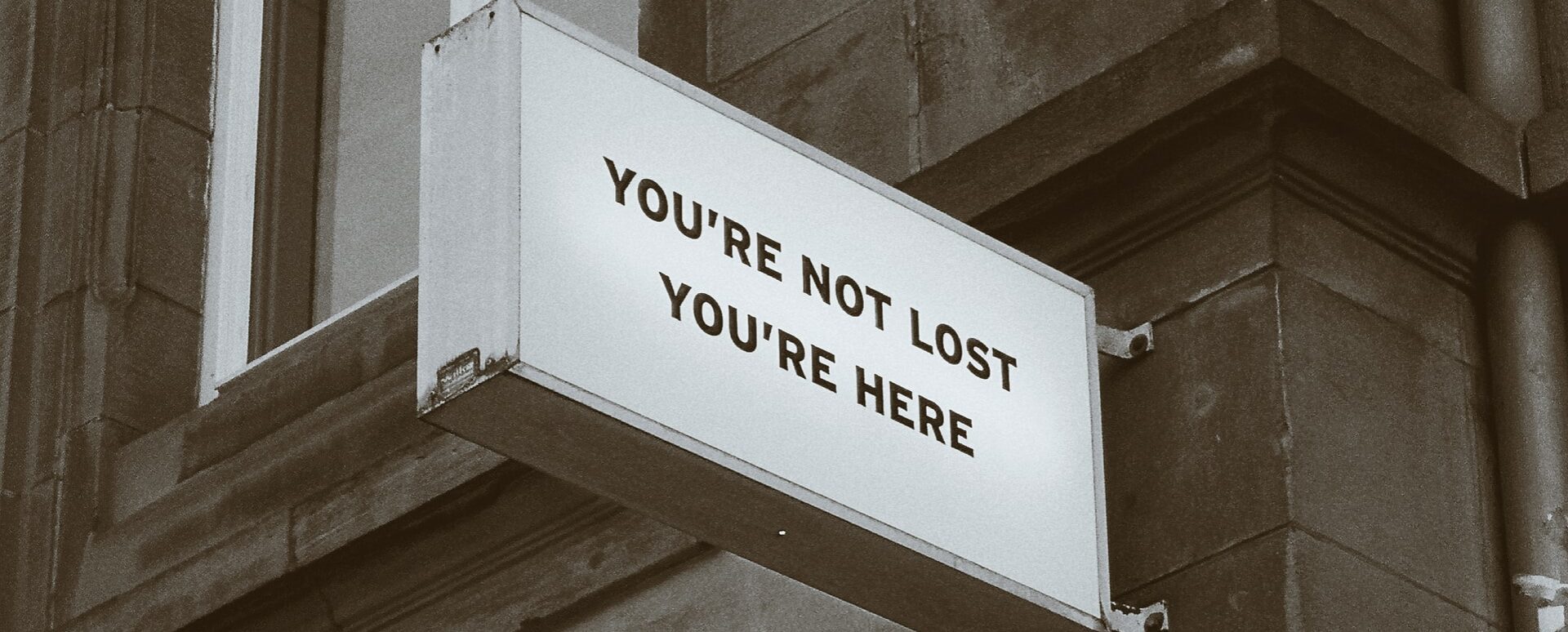 you're not lost you're here sign